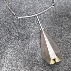 This piece is hand-fabricated and hollow formed from Sterling Silver sheet and 18kt bimetal. The piece is sanded and textured for for a more three- dimensional effect. Sterling silver square rod is also incorporated. One of a kind.