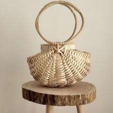 basket purse with light wood weave and full circle handles.