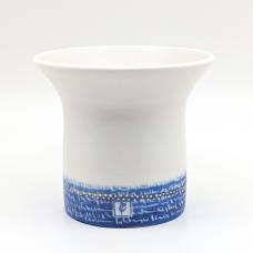 White vase accented with gold dots and persian writing in blue.