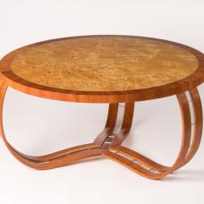 Random burls and dazzling grain are encircled by American cherry in a 'waterfall' edge pattern. Three interlocked legs  using the bent lamination technique  complete this elegant design. (mappa burl  American cherry  aluminum inlay)