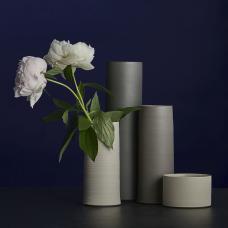 cluster of four simple cylindrical vases of varying heights and earthy hues