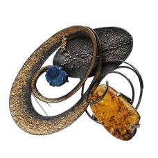 Expertly crafted through hammering and fusing  this jewelry piece harmonizes platinum  22k pink gold  24k gold  925 silver  amber  and azurite. Each element blends seamlessly  creating a mesmerizing fusion of texture and color.