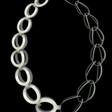 Neckpiece hand pierced and hand formed from brass sheet metal and powder coated cream.