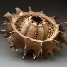 porcelain vessel with carved gash down the center