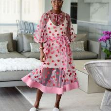 This skirt features side seam pockets and an elasticized waistband for a simple comfortable fit  and a self-tie belt attached at the side seams.