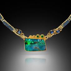 Hand-woven collar with tanzanite and 20k gold beads. Hand fabricated bezel with 22k gold  set with a colorful boulder opal from Australia  small faceted tsavorites  and blue rose cut sapphires