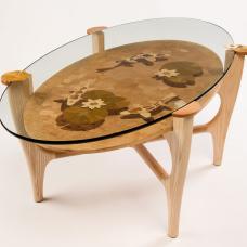 The koi pond within this table is a work of marquetry. Each piece of wood is cut by hand and fitted to create the image. I use the double-bevel technique to obtain fine detail. (Ash  ash burl  walnut  butternut  holly  laurel burl  mahogany  ebony  and dyed poplar)