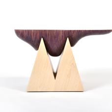 Inspired by the naturally formed beauty of geodes  this side table combines our Nerikomi wood with a solid ash wood base. The Nerikomi wood top was hand sculpted to nest onto the top of the geometric triangular wood base.