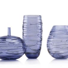The INCISION SERIES of bottles + vases are created using a “stuffed cup” technique. A cup is blown  cooled  cut  brought back up to temperature and reformed into each shape we offer. Offered in translucent monochromatic color ways to emphasize the unique torn texture.