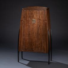 A cabinet in Claro walnut standing on cast bronze legs.This is my third piece from a heavily figured Claro walnut plank  all using shop-made Mokume-gane hardware to complement and echo the figure in the wood. Cast bronze legs lend visually slim yet solid support to the cabinet.