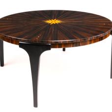 This elegant coffee table is made in the Art Deco style. The tabletop is Macassar ebony in a pie-matched pattern with Mother of Pearl inlay. An inlaid 16-point compass rose adorns the center. Legs are ebonized ash. A polished piano finish enhances the beautiful colors of this wood.