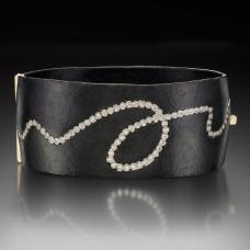 Formed and fabricated Iron locking cuff with an 18K Yellow Gold box clasp  and Diamonds set 18K Palladium White Gold bezels.