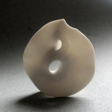 Porcelain twisting mobius piece. It has a unglazed surface.