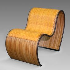 This 3-bend curved chair was custom-bent to my specs on an 8-layer plywood including the outside zebrawood veneer. The cushion was handwoven from individually hand-cut  edge-thinned and edge-dyed bridle leather strips to create a tight weave and a smooth feel.