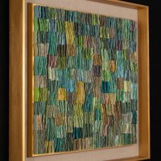 Double-sided handmade abaca/linen paper  folded  cut  attached to backing. Shown in gold painted wood shadow box