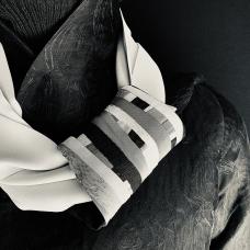 Silk scarf with attached holder made of silk pieces sewn and collagen creating surface design and functional detail that ends of scarf slide through. (Shown over our angle pointed silk reversible jacket)