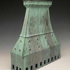 hollow, tower-like clay form with weathered bronze look.