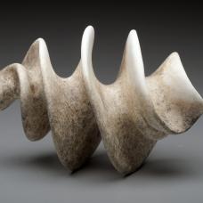 Porcelain corkscrew form with rough grimey exterior.