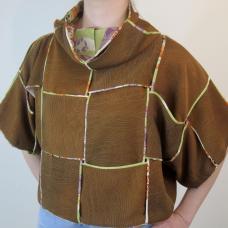 I made ribbons out of two different pieces of 100% silk fabric  then wove the ribbons together vertically and horizontally. The fabric has a different sheen when oriented vertically and horizontally  creating an interesting checkerboard pattern.