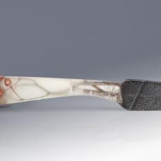 Moss  branches  seeds frozen in a resin handle hold a feather pattern blade of house made Damascus steel