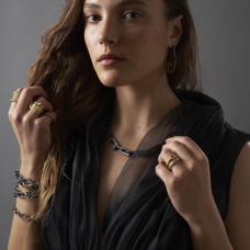 model wearing sterling silver and 18k gold assortment of rings  earrings  bracelet  and necklace.