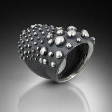 carved double domed ring in oxidized silver with varying sizes of bumpys.