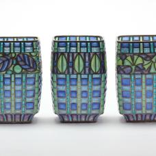 Materials: Enamel  sterling silver. Technique: Plique a Jour-- I construct a sterling framework  then fill openings with enamel powders and fire in furnace until it fuses to the silver. This is repeated until the openings are filled. Surface tension keeps the molten glass in place during firing.