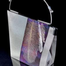Handbag made of stainless steel mesh decorated with natural feathers. Adjustable handle made of aircraft cable