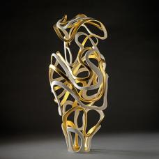 Porcelain that has been carved and accented with gold gild.