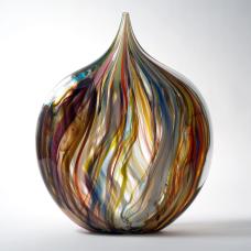 Blown glass form with painterly streaks of color that draw a heart shaped form. Randomly placed windows of clear glass magnify areas of the lively pattern. The vibrant array of colors remind us of a fresh box of crayons.