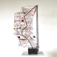 Copper wire and steel motorised kinetic sculpture. The sculpture is activated by a chain that lifts steel marbles to the top of the piece. The marbles roll down the sculpture on one of three paths and interact with nine moving elements. Kiln-fired enamelled copper parts function as counterweights.