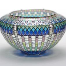 Materials: Enamel  sterling silver. Technique: Plique a Jour-- I construct a sterling framework  then fill openings with enamel powders and fire in furnace until it fuses to the silver. This is repeated until the openings are filled. Surface tension keeps the molten glass in place during firing.