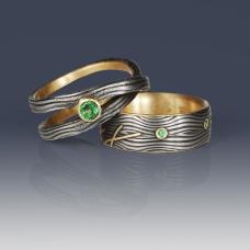 Housemade Damascus steel rings with 18K gold interiors and accents. Tsavorite garnets