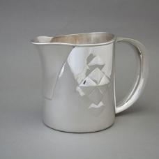 Hand Raised Sterling Silver Pitcher featuring a hollow silver handle and hand-chased decoration.