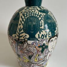 cermic vase, the top half is decorated with black and white sgraffito, the bottom half decorated in multicolored glaze illustrations.
