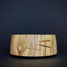 A straight sided bowl with colors sliding down the sides. Ties of Cherry and Walnut bind the cracks.