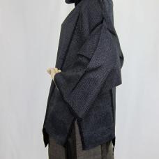 Oshima Tsumugi is a high-quality fabric that is 100% silk  plant-dyed  and hand-woven. The top is dyed with real indigo. The skirt is mud-dyed. In order to preserve the beauty of the fabric  I incorporated the hand weaving into the design  which is visible on the edge of the cloth.