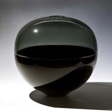 Tone on tone incalmo sphere with a dense black bottom and a transparent gray top.
