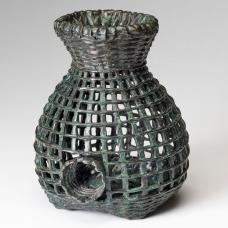 cast bronze fish trap basket with green highlights.