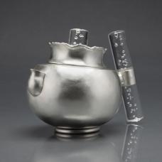 A fully functional sterling silver teapot. The piece is all hand fabricated from flat sheets of sterling silver. The form was hammered from a flat sheet of silver up into a three dimensional form. The lid and handle was fabricated from silver sheet as well. The handle and finial are acrylic.