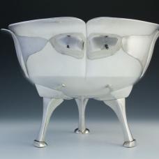 The bowl of this piece was hammered out of single large ingot of hand-poured silver and then raised into form. The long elegant legs were sandcast individually