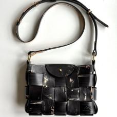 This bag is hand-sewn with saddle-stitching and created using natural vegetable-tanned leather that has been brush-painted with black and grey leather dyes onto each side. Glimpses of the natural vegetable-tanned leathers' original color are revealed in undyed areas. Brass button stud closure.