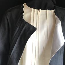 Silk/wool reversible jacket shown over matching top. Linear surface design created by detailed folding and stitching.