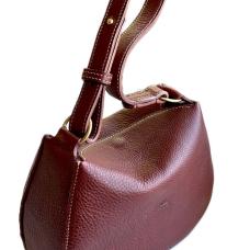 The Hobo Arc Bag is hand-stitched with cream colored waxed thread and crafted with dark red  pebbled vegetable-tanned leather. A reinforced center panel has been lined with thin veg-tan dyed to color match. Features a hidden magnet closure  an adjustable short strap and solid brass O-rings.