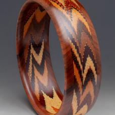 12 different specie of wood and artist dyed Maple veneer. 1000 individual pieces of wood