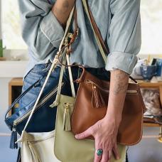 model holding a leather bags in a range of colors
